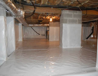 Basement crawlspace covered with thick moisture barrier with no visible insulation.